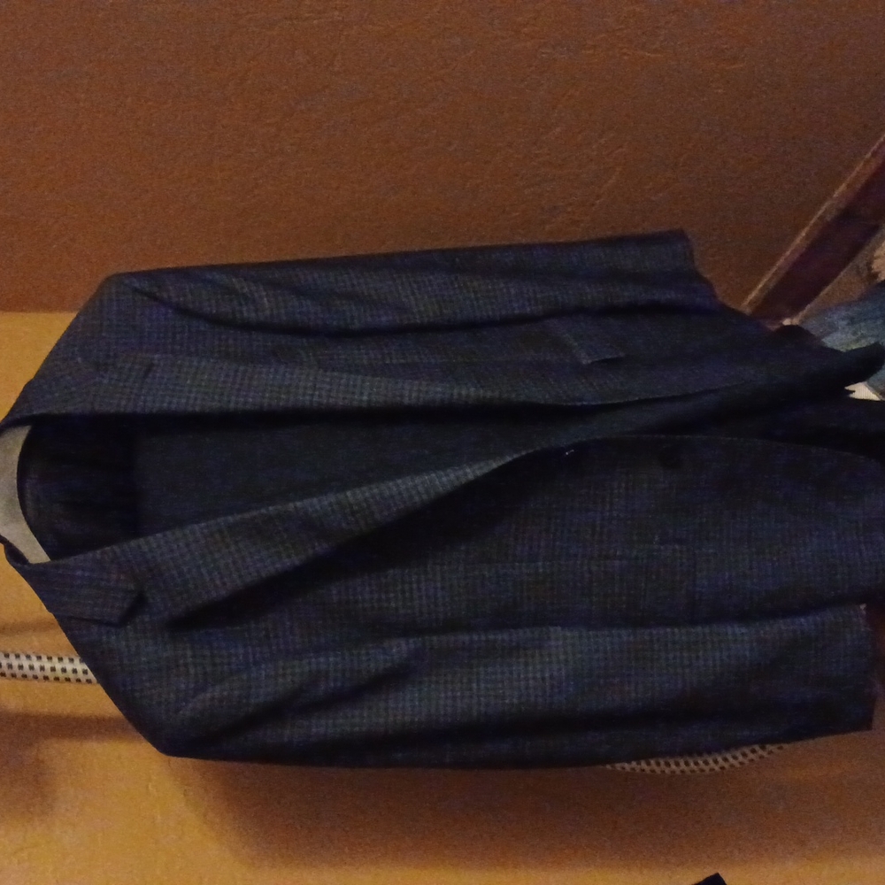 It is a nice dark blue suit made out of 100% wool in the pants it has buttons sp